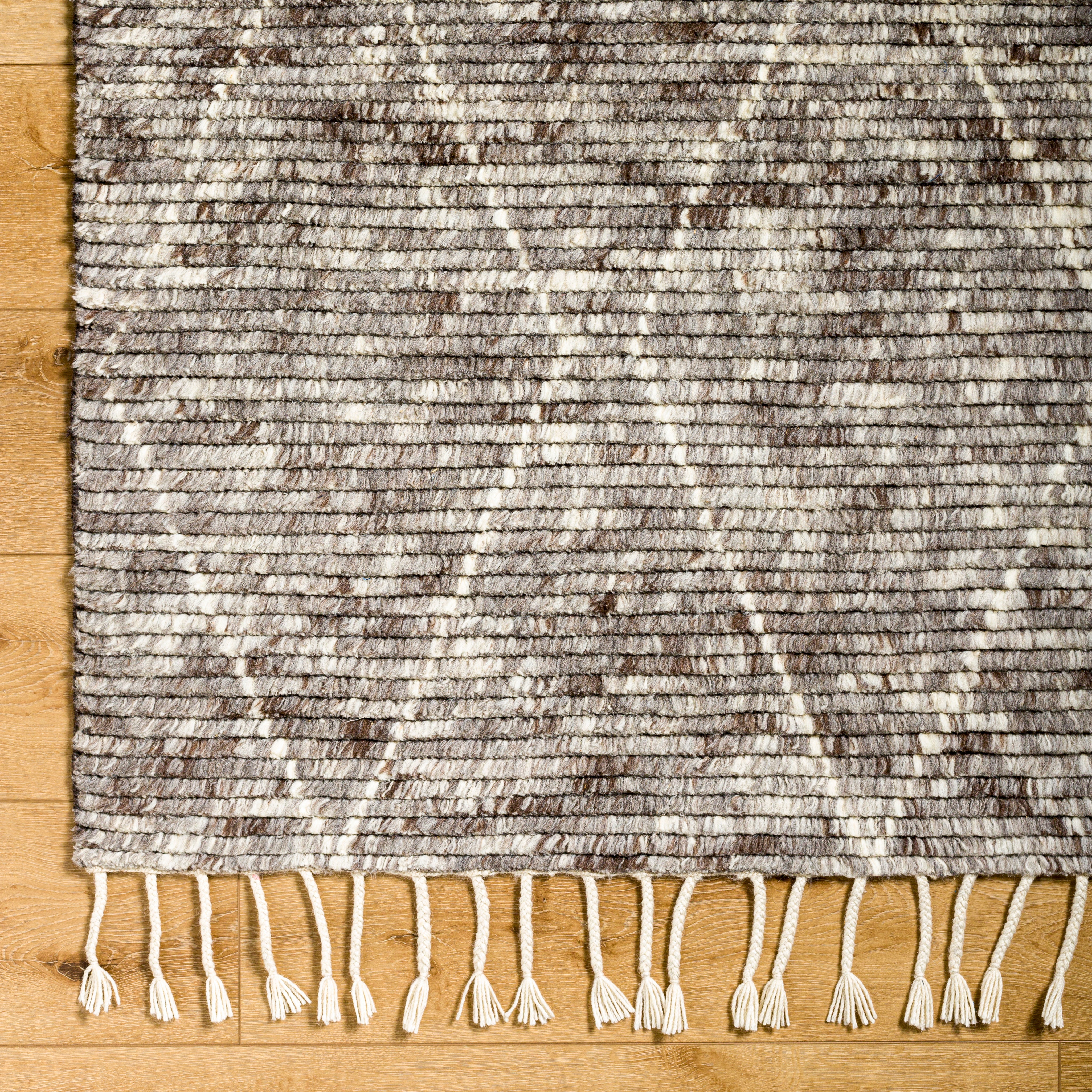 The Camille Jasper Wolf hand-knotted rug features a yummy blend of charcoal greys and chocolate brown.  Soft to the touch and made of dreamy, knotted wool in a low shed blend. Amethyst Home provides interior design, new home construction design consulting, vintage area rugs, and lighting in the Winter Garden, Florida metro area.