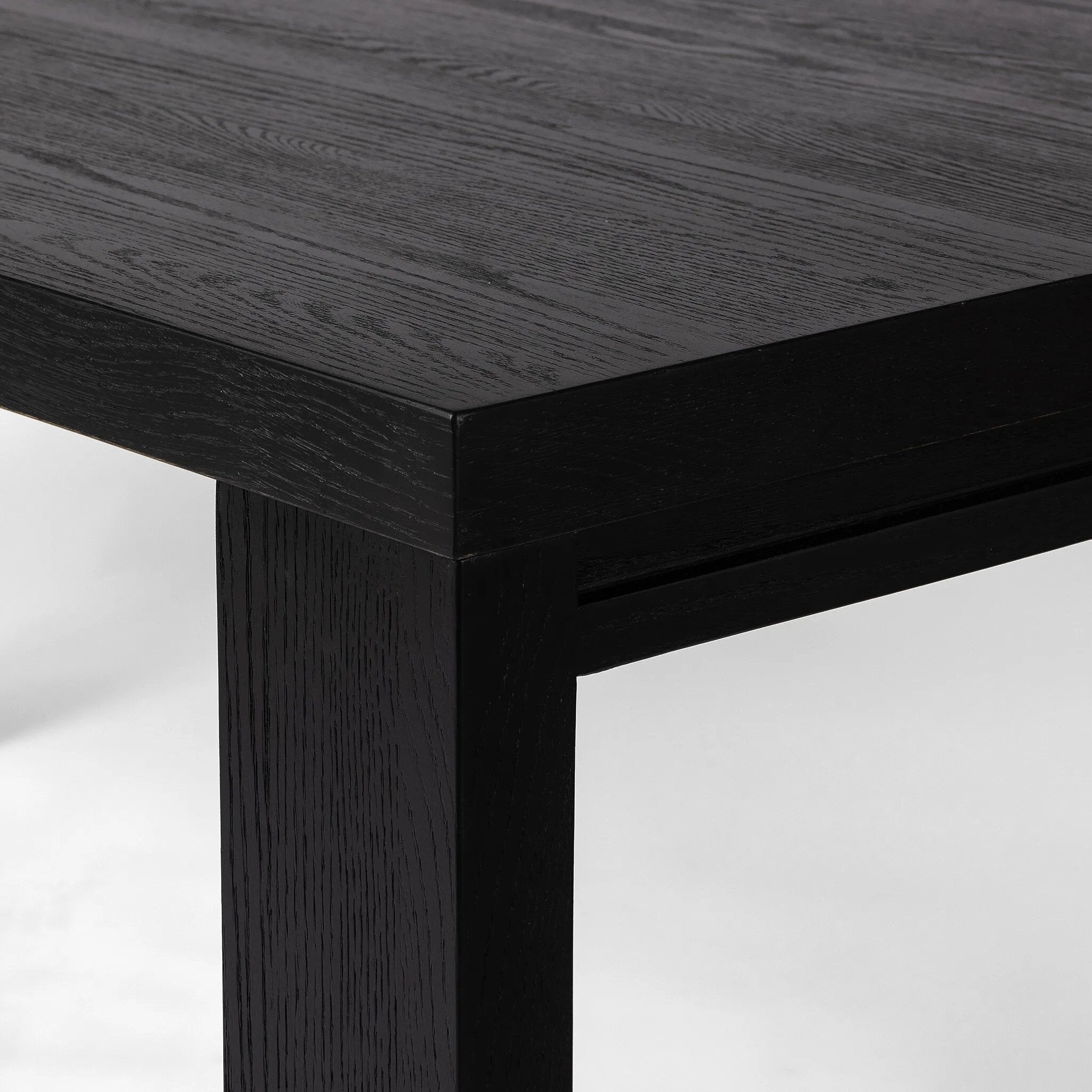 Angled legs place a modern twist on the timeless Parsons table. Versatile black-finished oak moves between styles and color palettes with ease.Collection: Irondal Amethyst Home provides interior design, new home construction design consulting, vintage area rugs, and lighting in the Newport Beach metro area.