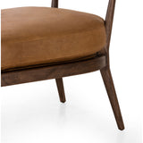 Safari styling is brought to modern speed on this vintage-inspired chair. Its solid wood frame features a webbed seating structure that brings a sink-in feel to the entire piece. The upholstered back, strap details and loose cushion are finished in carbon neutral, vegetable-tanned leather processed using naturally fallen eucalyptus leaves in Uruguay. Amethyst Home provides interior design, new construction, custom furniture, and area rugs in the Newport Beach metro area.