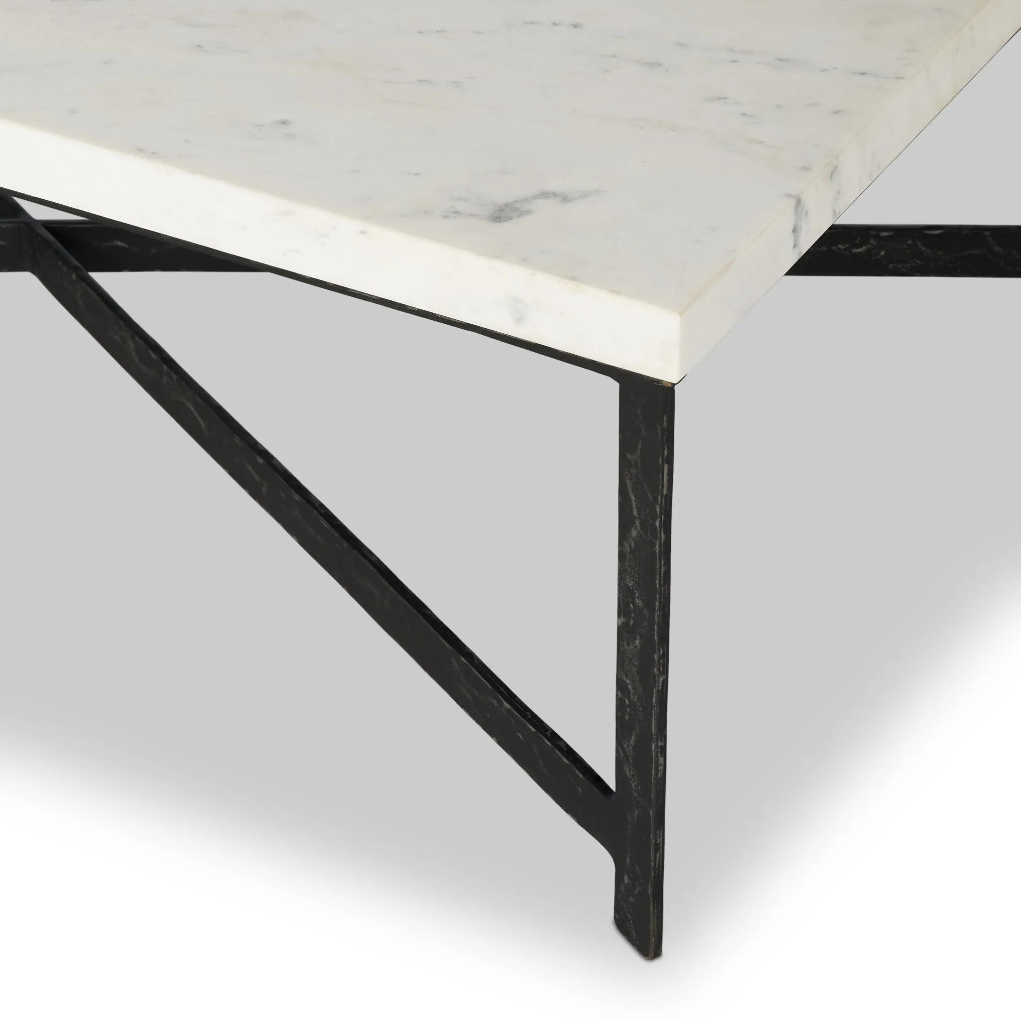 An open, hand-hammered base of black iron supports a rectangular tabletop of white marble, for a beautifully streamlined look with rustic vibes.Collection: Elemen Amethyst Home provides interior design, new home construction design consulting, vintage area rugs, and lighting in the Newport Beach metro area.