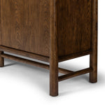 A beautifully simple statement piece. This three-door cabinet is crafted from a mix of solid oak and veneer in a dark toasted finish. Details include subtle, tapered corner posts and minimal rounded door knobs.Collection: Well Amethyst Home provides interior design, new home construction design consulting, vintage area rugs, and lighting in the Kansas City metro area.