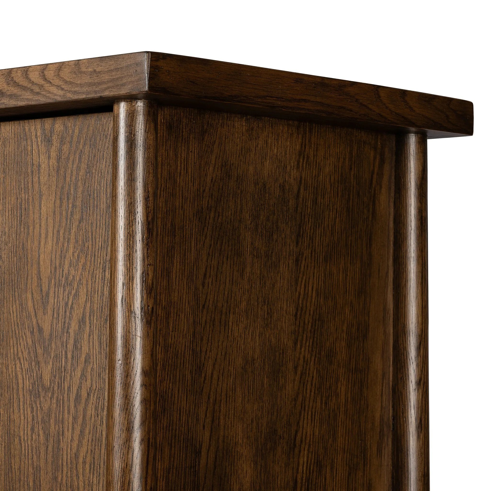 A beautifully simple statement piece. This three-door cabinet is crafted from a mix of solid oak and veneer in a dark toasted finish. Details include subtle, tapered corner posts and minimal rounded door knobs.Collection: Well Amethyst Home provides interior design, new home construction design consulting, vintage area rugs, and lighting in the Salt Lake City metro area.