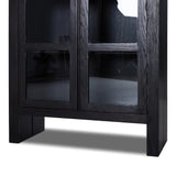 This minimal-inspired bookcase is crafted from a mix of solid oak and worn black veneer. Featuring glass-front doors and spacious shelves for storage and display.Collection: Bennet Amethyst Home provides interior design, new home construction design consulting, vintage area rugs, and lighting in the Alpharetta metro area.