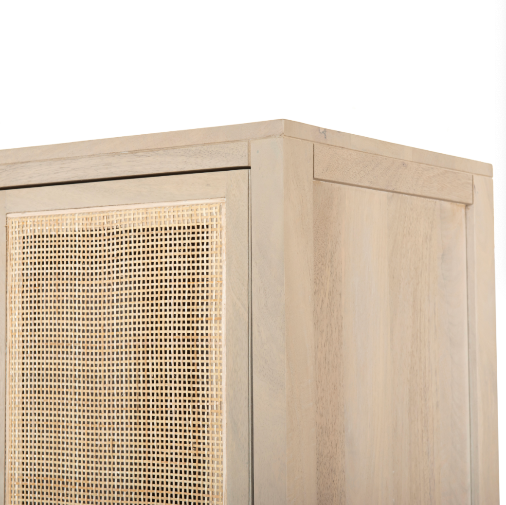 Natural mango wood encases textural cane doors which open to reveal spacious interior storage with this Caprice Cabinet - Natural Mango. A simple Parsons-style base keeps things open and airy for any dining room, bedroom, or other area.   Overall Dimensions: 59.00"w x 17.00"d x 69.00"h