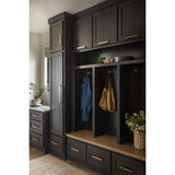 Dark wood mudroom locker with hooks and storage drawers in a home setting.