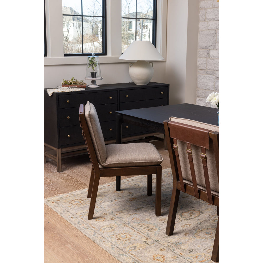 Featuring Wilmington Alcala Fawn Dining Chair by Four Hands at Amethyst Home. An Amethyst fave -- the Wilmington dining chair has a gorgeous coffee colored textile paired with medium toned wood and interesting leather buckles on the back -- we tied in the gold buckles with the gold chandelier above!  Inspired by the folded pillow form, the seat and back cu. Amethyst Home provides interior design, new home construction design consulting, vintage area rugs, and lighting in the Washington metro area.