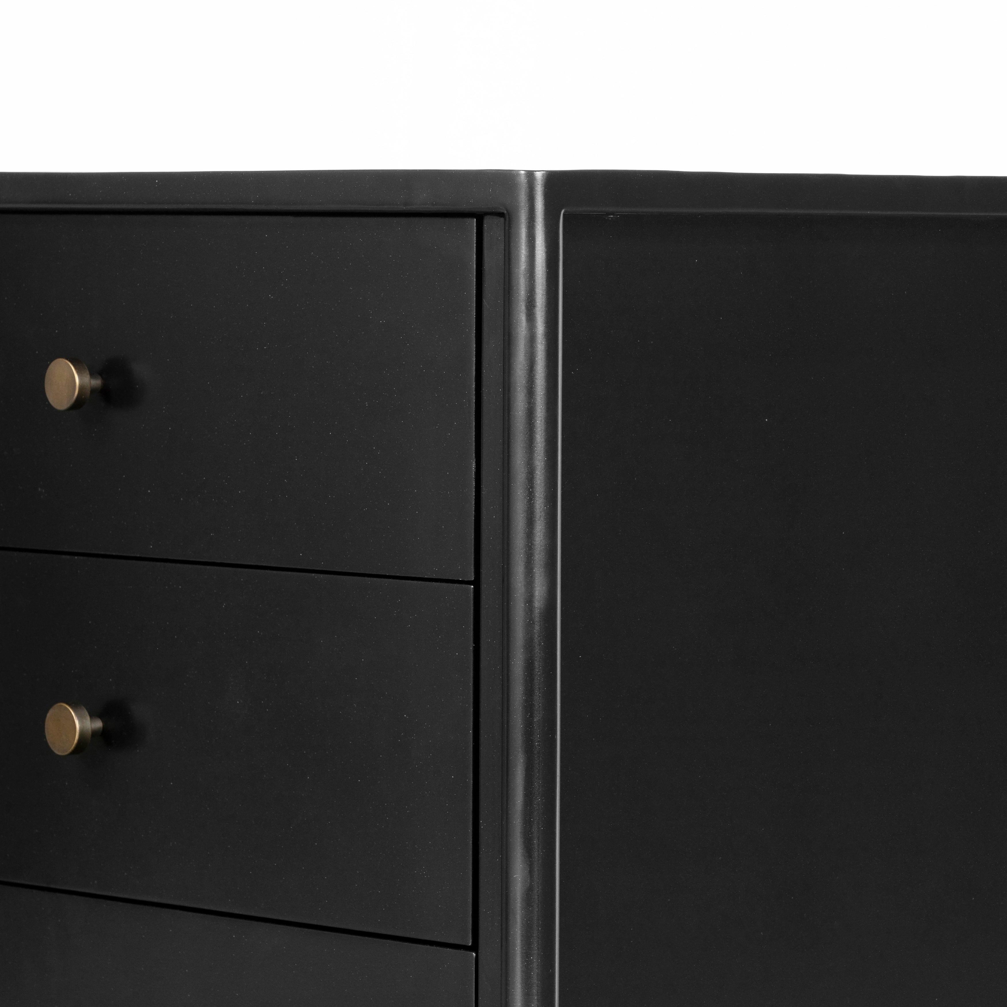 Bring a clean, beautifully industrial look to the bedroom with a three-drawer dresser made from black-finished iron, featuring bronzed iron hardware.