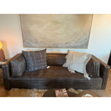 The Clemence Sofa features a minimalist design with clean, low-profile lines, complemented by plush cushions and luxurious throw pillows. Amethyst Home provides interior design, new home construction design consulting, vintage area rugs, and lighting in the Houston metro area.