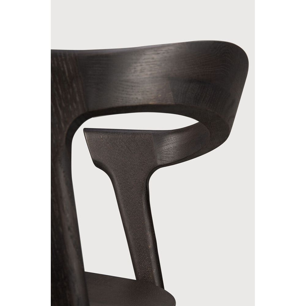 Over the years, the Bok dining chair has become one of our most recognisable designs. Designer Alain van Havre combines sculptural elegance and contemporary crafting into a graceful and airy form.

Seating height: 46cm - 18".
Made from brown tainted oak with a varnish finish. Amethyst Home provides interior design, new construction, custom furniture, and area rugs in the Omaha metro area