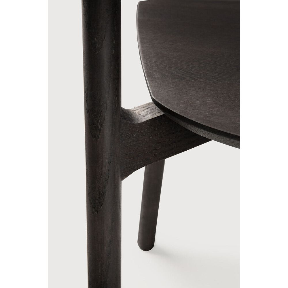 Over the years, the Bok dining chair has become one of our most recognisable designs. Designer Alain van Havre combines sculptural elegance and contemporary crafting into a graceful and airy form.

Seating height: 46cm - 18".
Made from brown tainted oak with a varnish finish. Amethyst Home provides interior design, new construction, custom furniture, and area rugs in the San Diego metro area