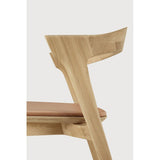 Featuring Bok Sienna Leather Varnished Oak Dining Chair by Ethnicraft at Amethyst Home. Reminiscent of a goat's curved horns, the Bok collection combines sculptural elegance and contemporary crafting into a graceful and airy form. Over the years, the Bok dining chair has become one of Ethnicraft's most recognisable designs.Weight : 15 lbs Dimensions: 21.5" W x 20" L x 30" H. Amethyst Home provides interior design, new construction, custom furniture, and area rugs in the Tampa metro area