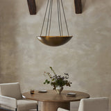 Featuring Branson Aged Brass Iron Chandelier by Four Hands at Amethyst Home. A wide, shallow bowl in aged brass with six sockets, diffusing light upward for an ambient glow. Suspended by six sleek cords, its streamlined design eschews traditional tension wires for a clean silhouette.Overall Dimensions: 26.00"w x 26.00"d x 7.75"hWeight : 17.09 lbsMaterials : Iron, Thermoplastic. Amethyst Home provides interior design, new construction, custom furniture, and area rugs in the Washington metro area