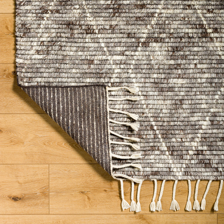 The Camille Jasper Wolf hand-knotted rug features a yummy blend of charcoal greys and chocolate brown.  Soft to the touch and made of dreamy, knotted wool in a low shed blend. Amethyst Home provides interior design, new home construction design consulting, vintage area rugs, and lighting in the Seattle metro area.