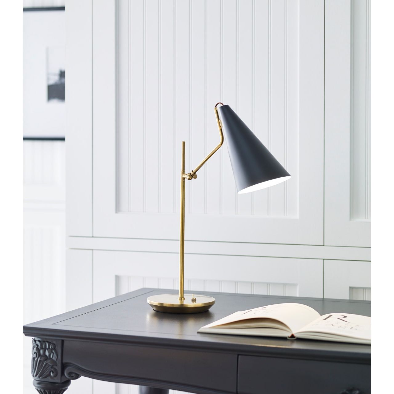 Featuring Clemente Table Lamp Brass with Black by Visual Comfort at Amethyst Home. The Clemente by AERIN offers refined angles and sleek detailing while lighting with elegant simplicity. Elongated conical shades provide a modern balance to a mid-century design with antique brass finishes. Any hallway or library will be enhanced with the Clemente, especially behind a favorite readin. Amethyst Home provides interior design, new construction, custom furniture, and area rugs in the Monterey metro area