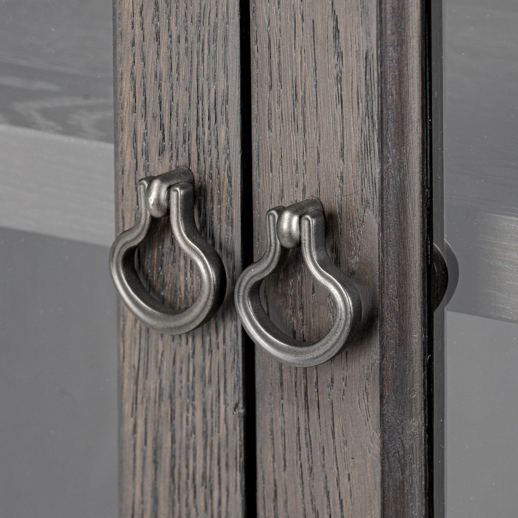 Baroque-period detailing gives this oak cabinet its  classic look. Made from black oak with a metal base and ring pulls, as well as cabriole-like legs to soften the lines Amethyst Home provides interior design, new home construction design consulting, vintage area rugs, and lighting in the Charlotte metro area.