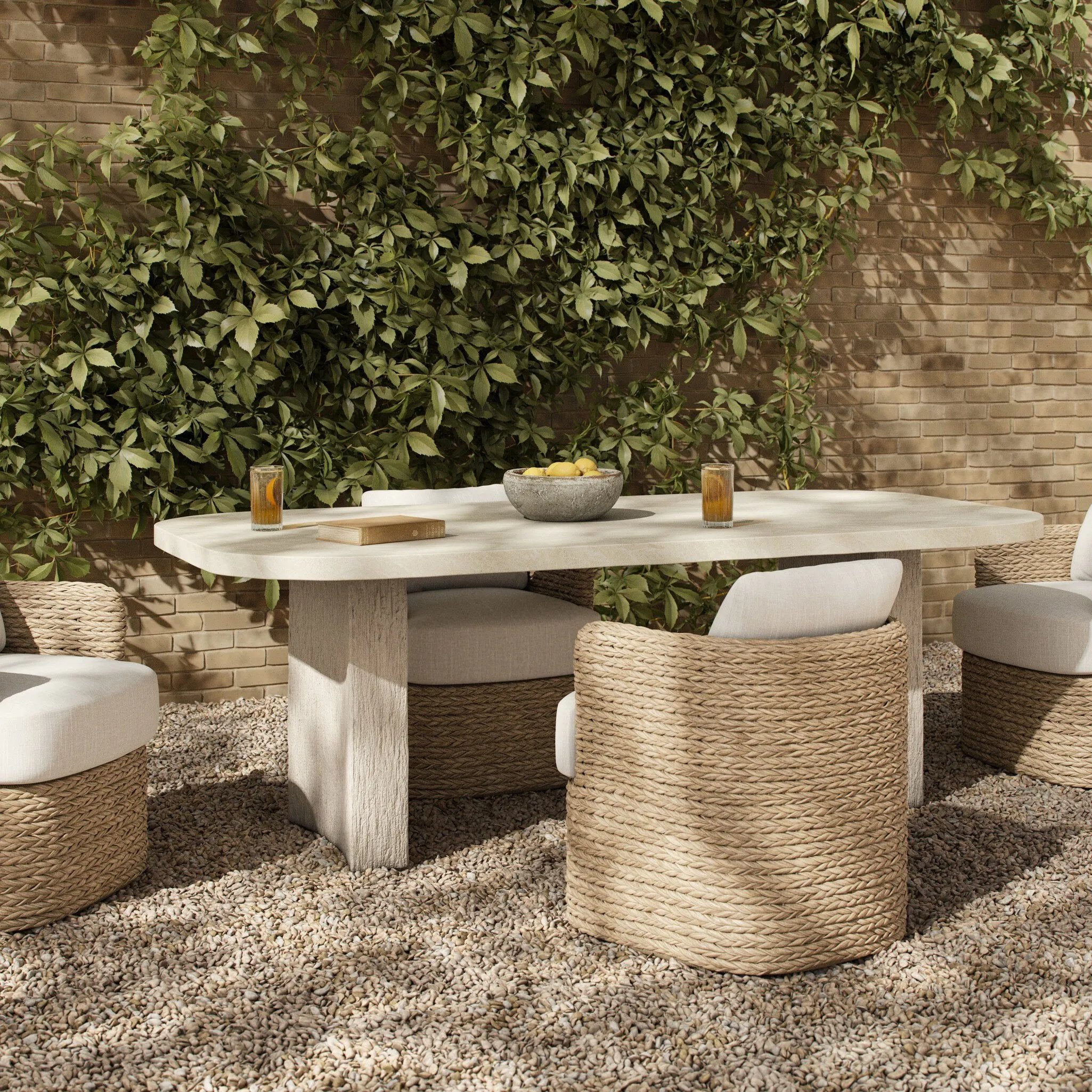 This outdoor dining table features a double pedestal silhouette that's defined by striking contrast between a smooth, refined top and heavily textured legs for a look that's straight from the quarry. It comes together with a water transfer technique on concrete that mimics natural marble. Amethyst Home provides interior design, new home construction design consulting, vintage area rugs, and lighting in the Calabasas metro area.