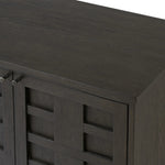 A transitional piece that works into your collection with ease. This solid oak sideboard is finished in a smoked black, highlighting natural graining inherent to rich character woods. Grid-like patterned doors bring dimension to clean, simple shaping, while interior shelving awaits storage of dinnerware, table linens and more. Amethyst Home provides interior design, new home construction design consulting, vintage area rugs, and lighting in the Dallas metro area.