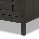 A transitional piece that works into your collection with ease. This solid oak sideboard is finished in a smoked black, highlighting natural graining inherent to rich character woods. Grid-like patterned doors bring dimension to clean, simple shaping, while interior shelving awaits storage of dinnerware, table linens and more. Amethyst Home provides interior design, new home construction design consulting, vintage area rugs, and lighting in the Newport Beach metro area.