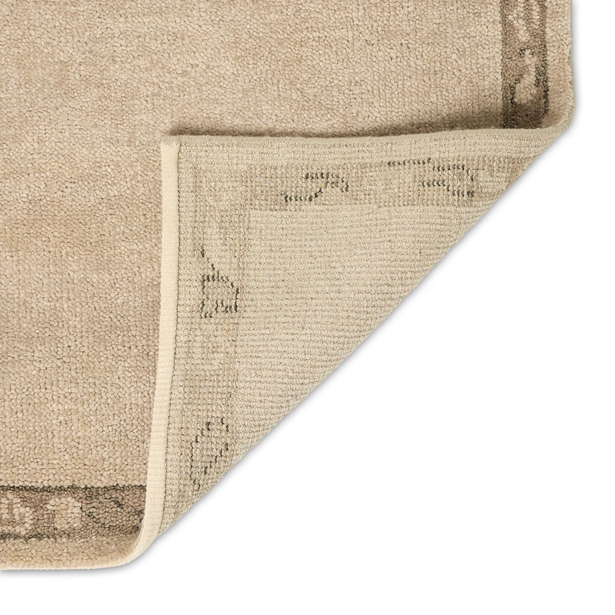 Patterned with a simplistic three-emblem motif framed by a narrow border, this hand-knotted wool rug adds just a touch of neutral design. The durable runner is crafted to wear beautifully over time. Due to the handcrafted nature of this rug, slight variations in sizing may occur Amethyst Home provides interior design, new home construction design consulting, vintage area rugs, and lighting in the Calabasas metro area.