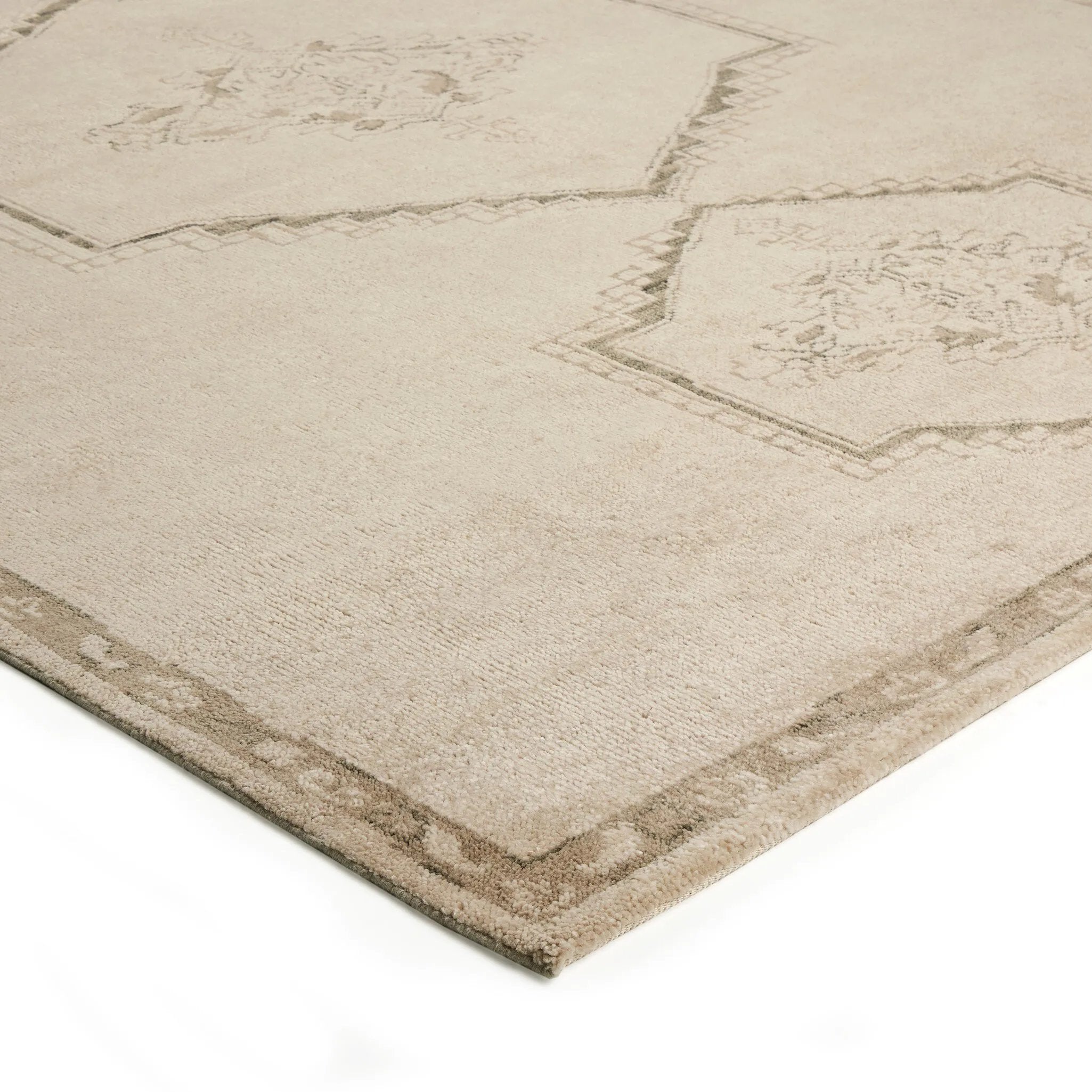 Patterned with a simplistic three-emblem motif framed by a narrow border, this hand-knotted wool rug adds just a touch of neutral design. The durable runner is crafted to wear beautifully over time. Due to the handcrafted nature of this rug, slight variations in sizing may occur Amethyst Home provides interior design, new home construction design consulting, vintage area rugs, and lighting in the Dallas metro area.