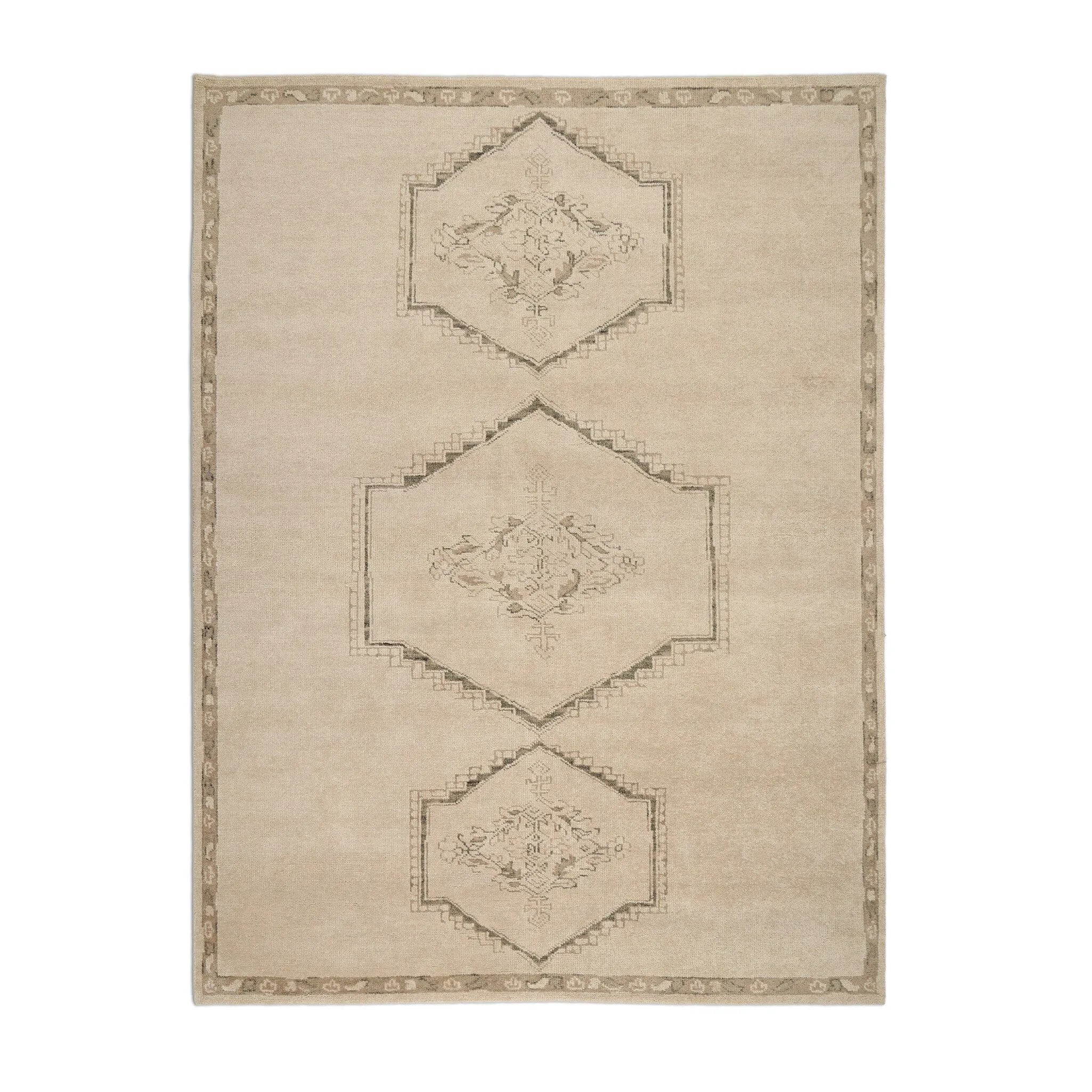 Patterned with a simplistic three-emblem motif framed by a narrow border, this hand-knotted wool rug adds just a touch of neutral design. The durable runner is crafted to wear beautifully over time. Due to the handcrafted nature of this rug, slight variations in sizing may occur Amethyst Home provides interior design, new home construction design consulting, vintage area rugs, and lighting in the Winter Garden metro area.