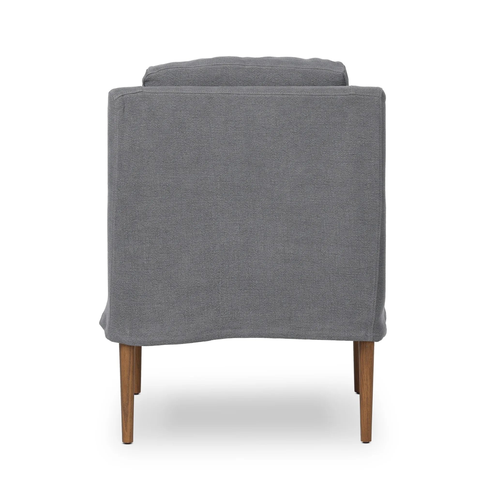 Heritage-inspired comfort. Sloping track arms are a study in playful forms, while the frame's fluid shape creates a simple, polished look. Tapered legs extend beyond a short skirt for a more relaxed style. Covered in 100% linen. A design collaboration by Amber Lewis and Four Hands. Amethyst Home provides interior design, new home construction design consulting, vintage area rugs, and lighting in the Austin metro area.