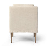 Heritage-inspired comfort. Sloping track arms are a study in playful forms, while the frame's fluid shape creates a simple, polished look. Tapered legs extend beyond a short skirt for a more relaxed style. Covered in 100% linen. A design collaboration by Amber Lewis and Four Hands. Amethyst Home provides interior design, new home construction design consulting, vintage area rugs, and lighting in the Alpharetta metro area.