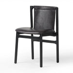 Featuring Baden Sonoma Black Dining Chair by Four Hands at Amethyst Home. Midcentury-inspired with its minimalist wooden frame, this armless dining chair features a low back and float-like seat upholstered in slightly distressed black top-grain leather exclusive to Four Hands. Leather wrap detailing for texture.Overall Dimensions: 19.75"w x 23.25"d x 32.25". Amethyst Home provides interior design, new home construction design consulting, vintage area rugs, and lighting in the Calabasas metro area.