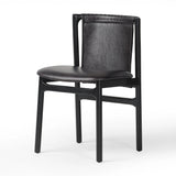Featuring Baden Sonoma Black Dining Chair by Four Hands at Amethyst Home. Midcentury-inspired with its minimalist wooden frame, this armless dining chair features a low back and float-like seat upholstered in slightly distressed black top-grain leather exclusive to Four Hands. Leather wrap detailing for texture.Overall Dimensions: 19.75"w x 23.25"d x 32.25". Amethyst Home provides interior design, new home construction design consulting, vintage area rugs, and lighting in the Calabasas metro area.