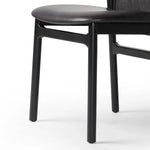 Featuring Baden Sonoma Black Dining Chair by Four Hands at Amethyst Home. Midcentury-inspired with its minimalist wooden frame, this armless dining chair features a low back and float-like seat upholstered in slightly distressed black top-grain leather exclusive to Four Hands. Leather wrap detailing for texture.Overall Dimensions: 19.75"w x 23.25"d x 32.2. Amethyst Home provides interior design, new home construction design consulting, vintage area rugs, and lighting in the Los Angeles metro area.