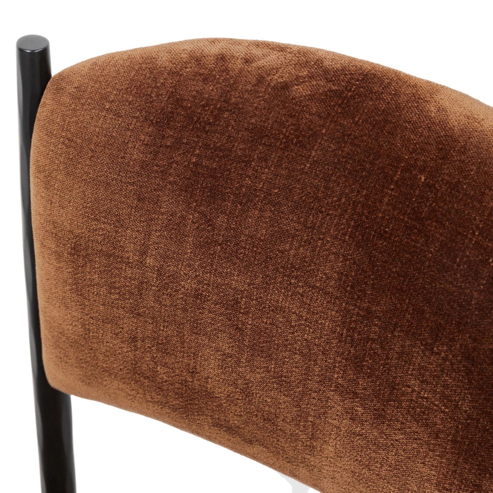 Bring a refreshed midcentury look — and pop of color — to your table. Comfortable seat and back cushions are upholstered in a velvety fabric with a soft, chenille-like feel, while slim, black-finished iron frame curves at the top to soften things up. Simple tapered legs complete the look. Amethyst Home provides interior design, new home construction design consulting, vintage area rugs, and lighting in the Omaha metro area.