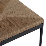 A steel dining chair frame is softened and paired with natural woven fibers. Thin, tapered legs and a tall channeled back cre