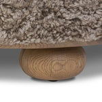For an extra seat or propped feet, this welcoming ottoman features a subtly tapered shape and a rounded base with bun feet beneath. Crafted from solid oak and upholstered with taupe shearling for extra texture Amethyst Home provides interior design, new home construction design consulting, vintage area rugs, and lighting in the Boston metro area.