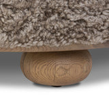 For an extra seat or propped feet, this welcoming ottoman features a subtly tapered shape and a rounded base with bun feet beneath. Crafted from solid oak and upholstered with taupe shearling for extra texture Amethyst Home provides interior design, new home construction design consulting, vintage area rugs, and lighting in the Boston metro area.