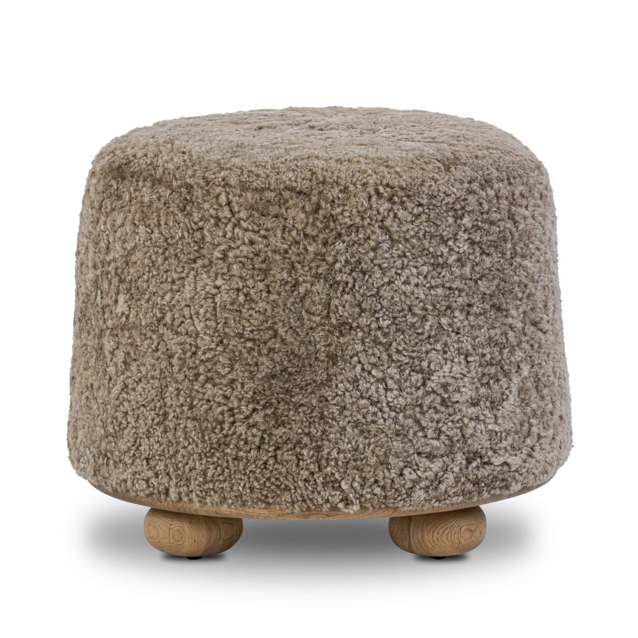 For an extra seat or propped feet, this welcoming ottoman features a subtly tapered shape and a rounded base with bun feet beneath. Crafted from solid oak and upholstered with taupe shearling for extra texture Amethyst Home provides interior design, new home construction design consulting, vintage area rugs, and lighting in the Omaha metro area.