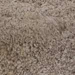 For an extra seat or propped feet, this welcoming ottoman features a subtly tapered shape and a rounded base with bun feet beneath. Crafted from solid oak and upholstered with taupe shearling for extra texture Amethyst Home provides interior design, new home construction design consulting, vintage area rugs, and lighting in the San Diego metro area.