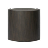Rich contours bring character to the bedside. A round black-finished oak table has a spacious cubby and a single drawer with metal glides and a bronzed pull Amethyst Home provides interior design, new home construction design consulting, vintage area rugs, and lighting in the Austin metro area.