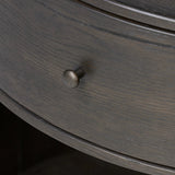 Rich contours bring character to the bedside. A round black-finished oak table has a spacious cubby and a single drawer with metal glides and a bronzed pull Amethyst Home provides interior design, new home construction design consulting, vintage area rugs, and lighting in the Des Moines metro area.