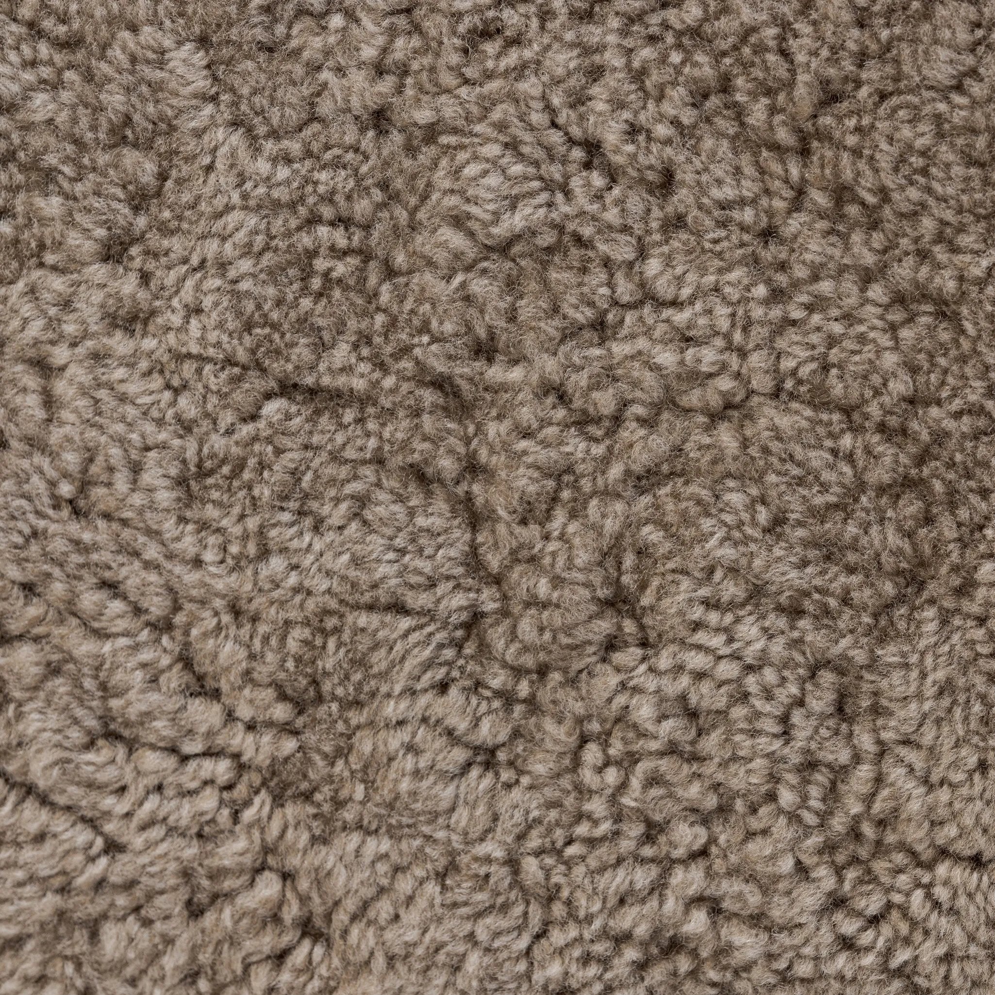 Soft texture and eye-catching contours fuse in this comfort-driven accent chair, pairing a low, luxurious shearling seat and 