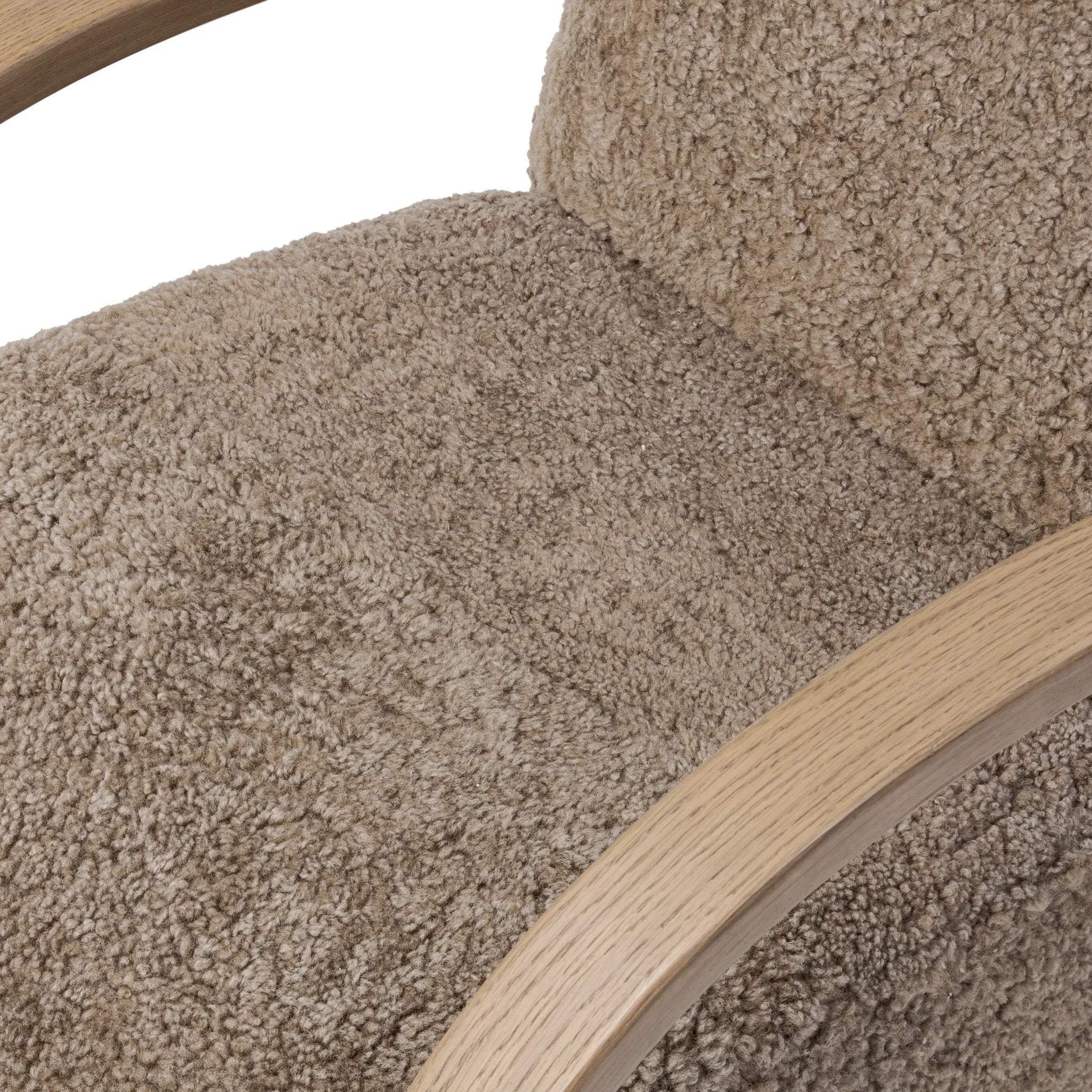 Soft texture and eye-catching contours fuse in this comfort-driven accent chair, pairing a low, luxurious shearling seat and 