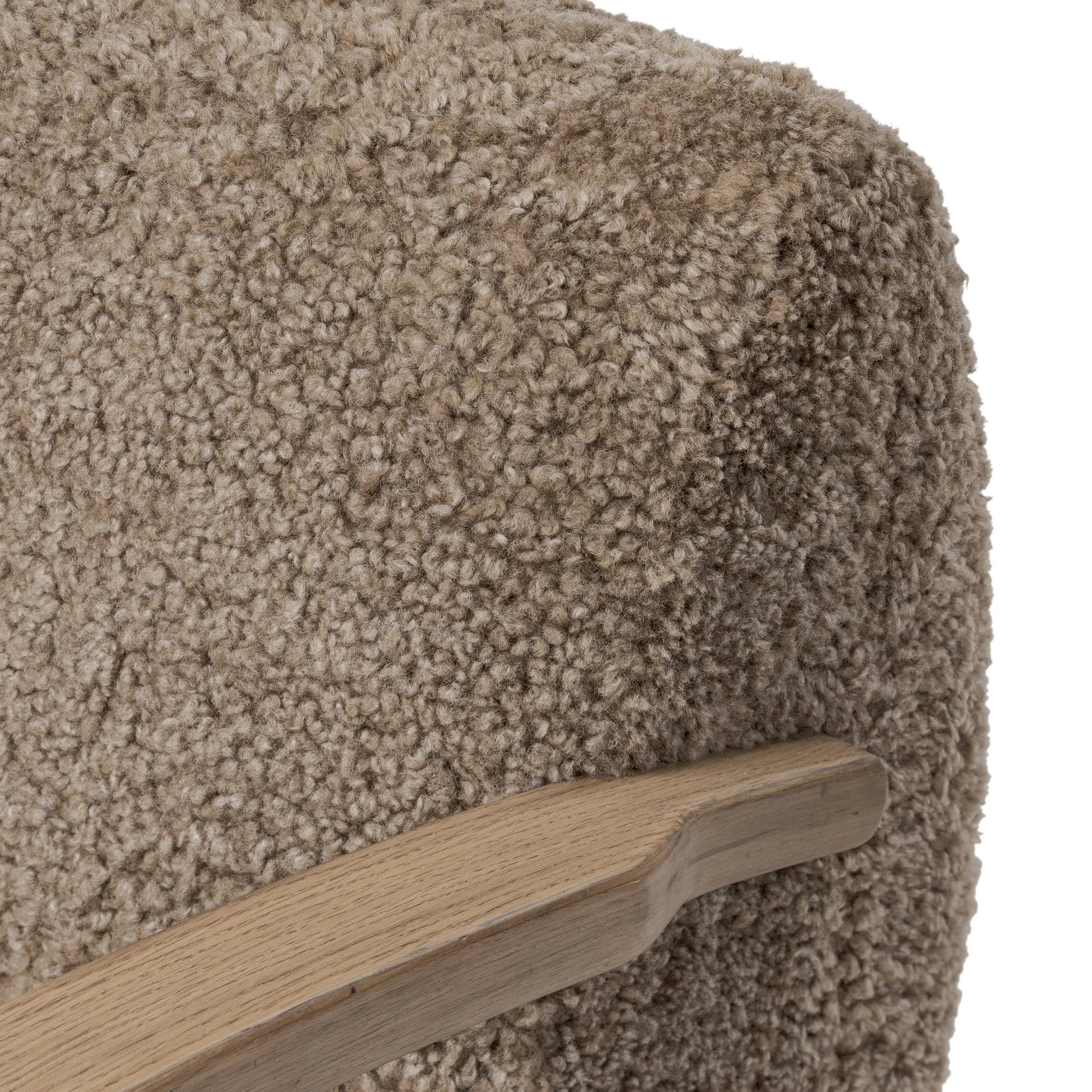 Soft texture and eye-catching contours fuse in this comfort-driven accent chair, pairing a low, luxurious shearling seat and 