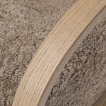 Soft texture and eye-catching contours fuse in this comfort-driven accent chair, pairing a low, luxurious shearling seat and 