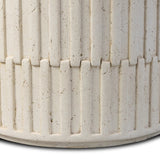 Cast concrete shapes a drum-style outdoor end table, with a linear pattern layered for added texture. Finished with a parchment-like textural feel. Cover or store inside during inclement weather and when not in use.As enthusiasts of luxe style at Amethyst, we love the optimistic inspired Callisto Outdoor End Table - Aged White Concrete. Amethyst Home provides interior design, new home construction design consulting, vintage area rugs, and lighting in the Washington metro area.