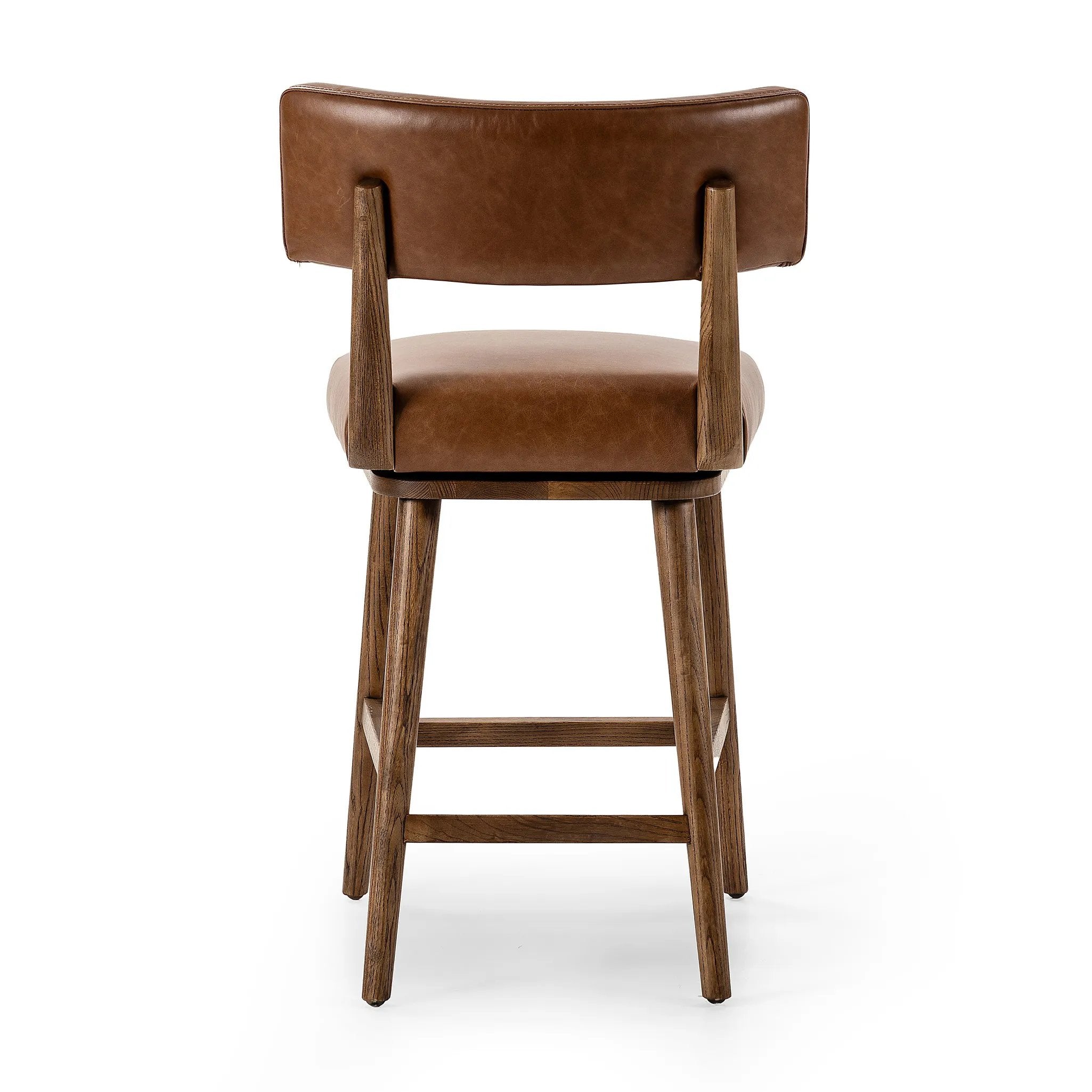 Featuring Cardell Sonoma Chestnut Swivel Bar + Counter Stool by Four Hands at Amethyst Home. This reimagined classic pairs a barrel back frame of solid nettlewood with top-grain leather in a rich chestnut. A 180-degree swivel with return memory tops off the piece with fresh functionality.BarOverall Dimensions: 21.50"w x 22.25"d x 42.50"hWeight: 24.25 lbsCounte. Amethyst Home provides interior design, new home construction design consulting, vintage area rugs, and lighting in the Dallas metro area.