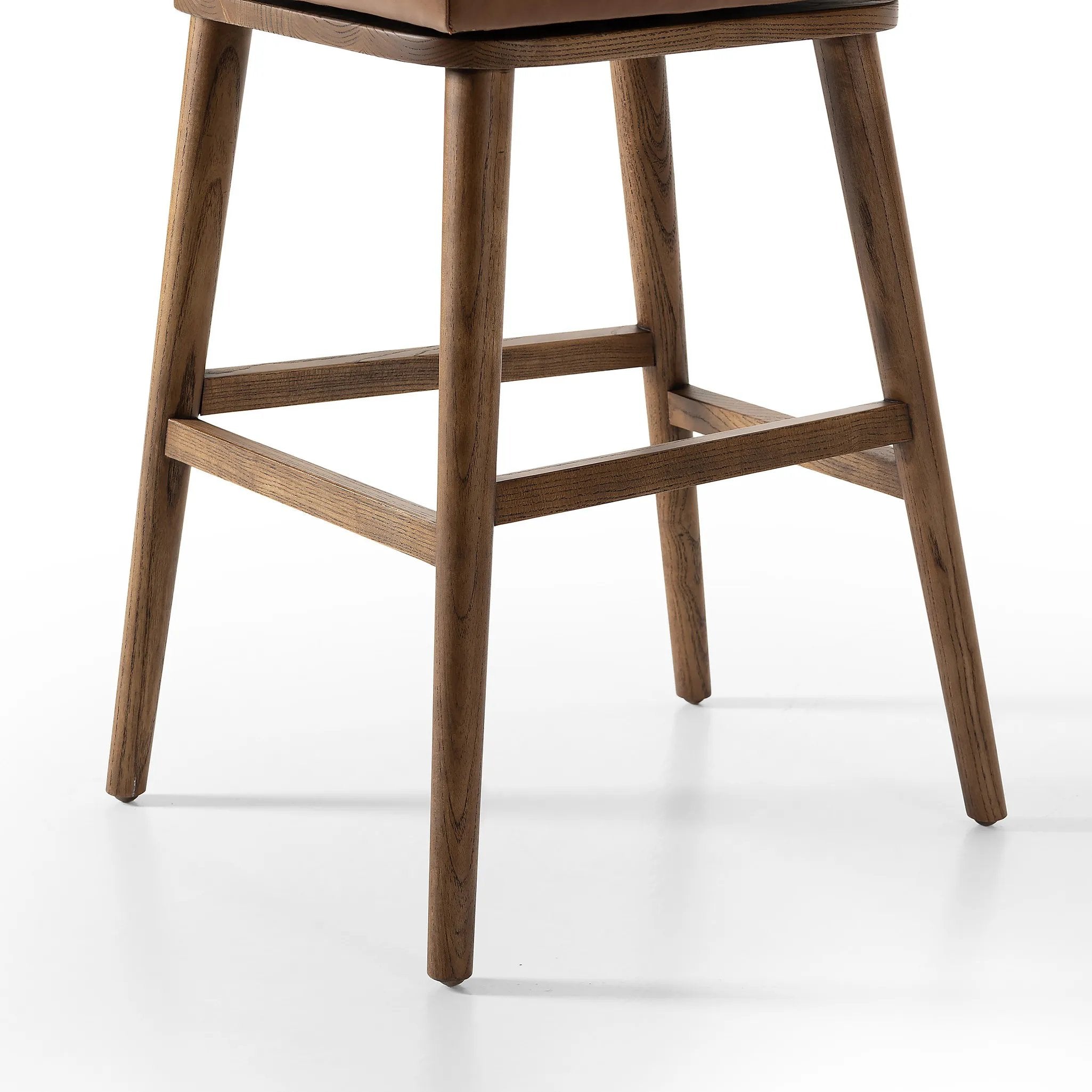 Featuring Cardell Sonoma Chestnut Swivel Bar + Counter Stool by Four Hands at Amethyst Home. This reimagined classic pairs a barrel back frame of solid nettlewood with top-grain leather in a rich chestnut. A 180-degree swivel with return memory tops off the piece with fresh functionality.BarOverall Dimensions: 21.50"w x 22.25"d x 42.50"hWeight: 24.25 lbsC. Amethyst Home provides interior design, new home construction design consulting, vintage area rugs, and lighting in the Kansas City metro area.