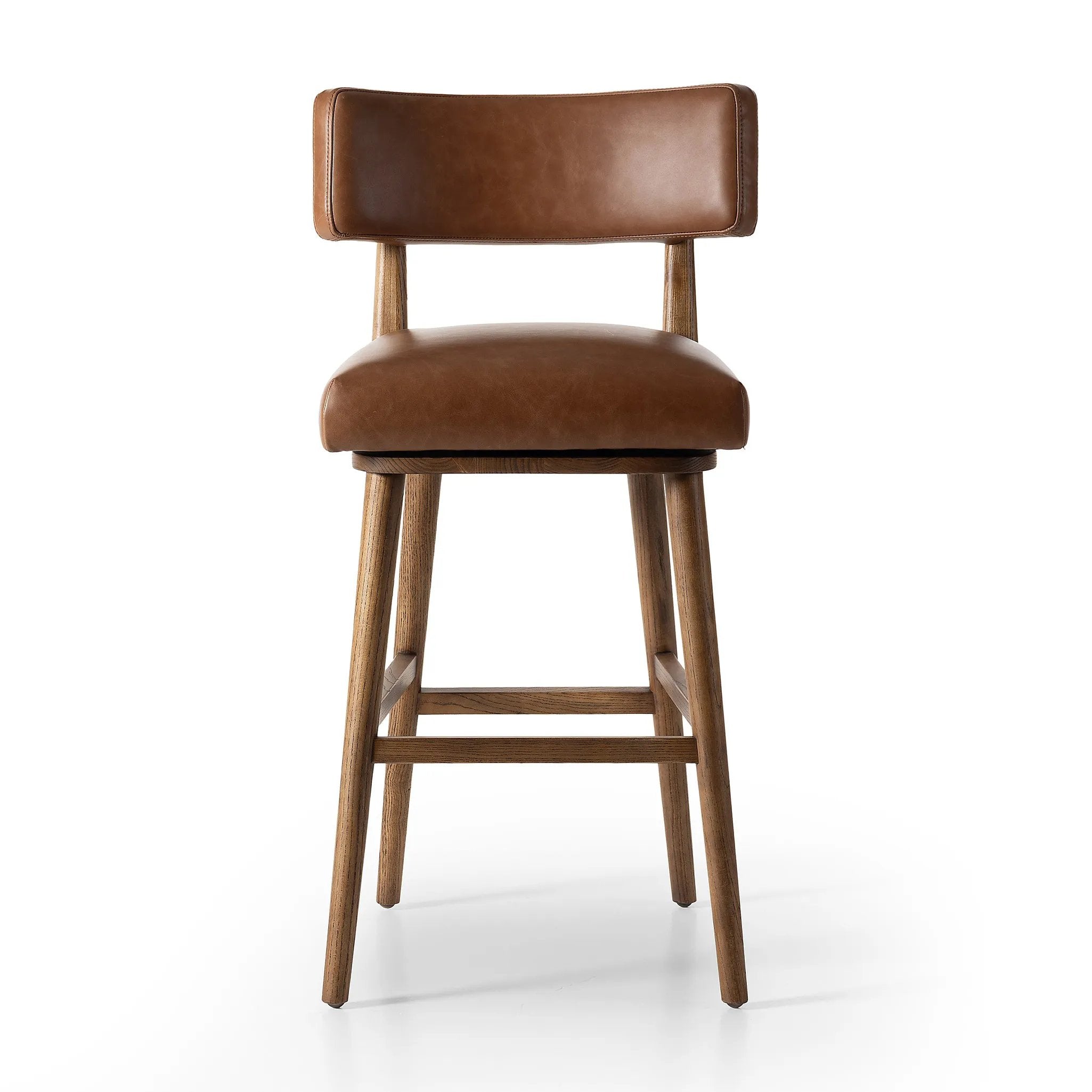 Featuring Cardell Sonoma Chestnut Swivel Bar + Counter Stool by Four Hands at Amethyst Home. This reimagined classic pairs a barrel back frame of solid nettlewood with top-grain leather in a rich chestnut. A 180-degree swivel with return memory tops off the piece with fresh functionality.BarOverall Dimensions: 21.50"w x 22.25"d x 42.50"hWeight: 24.25 lbsCou. Amethyst Home provides interior design, new home construction design consulting, vintage area rugs, and lighting in the San Diego metro area.