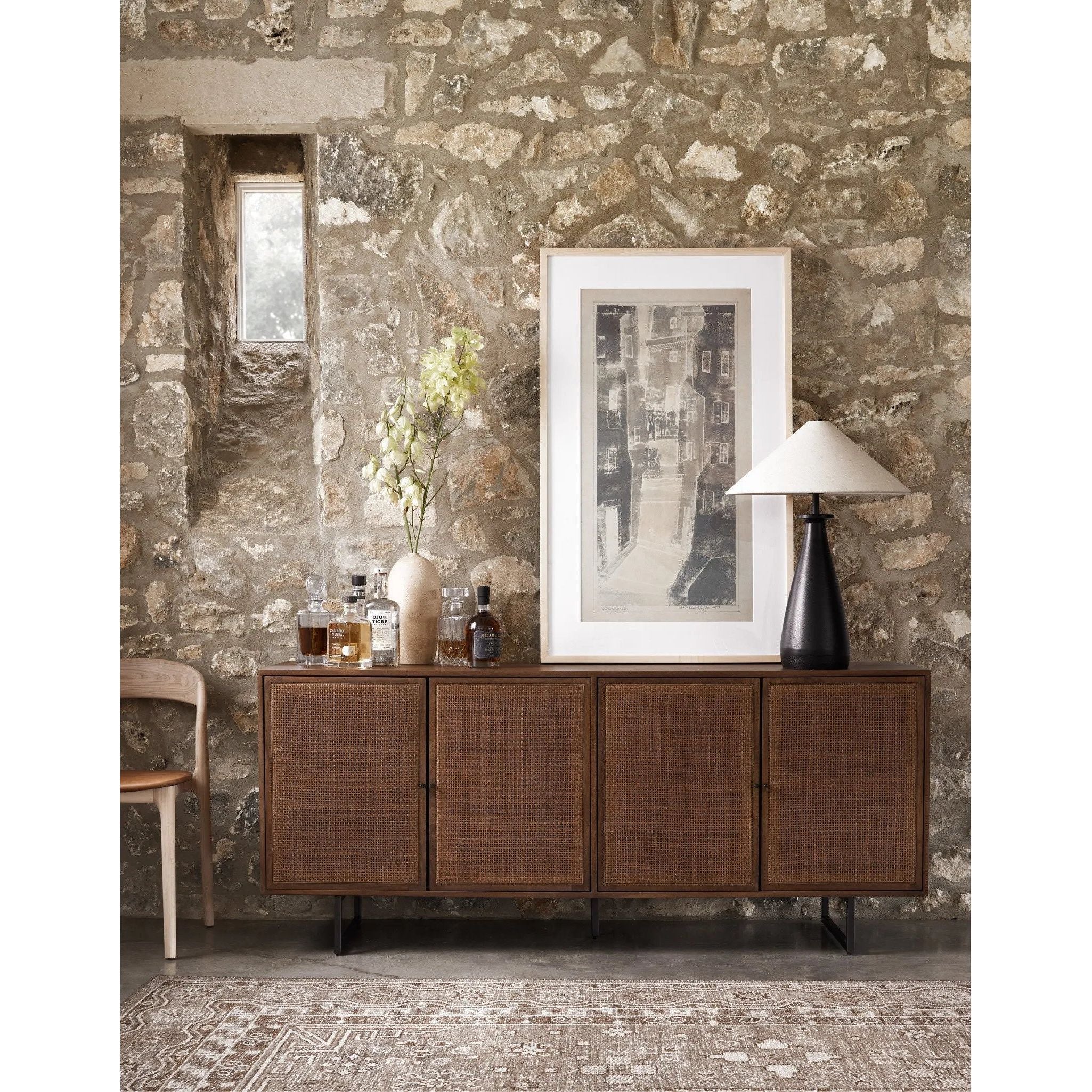 Midcentury-inspired style with an organic twist. Surrounded by brown-washed solid mango casing, cane door fronts weave for a 