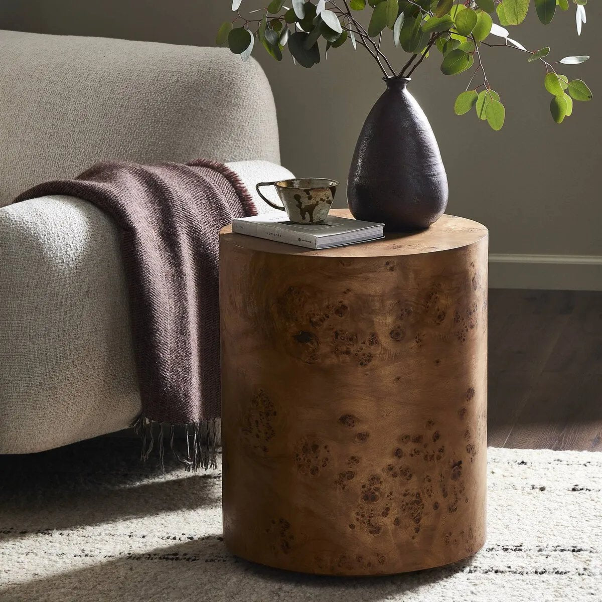 A simple drum shape showcases the natural artistry of the richly grained caramel burl veneer. Its compact size is ideal for smaller spaces.Collection: Hughe Amethyst Home provides interior design, new home construction design consulting, vintage area rugs, and lighting in the Los Angeles metro area.