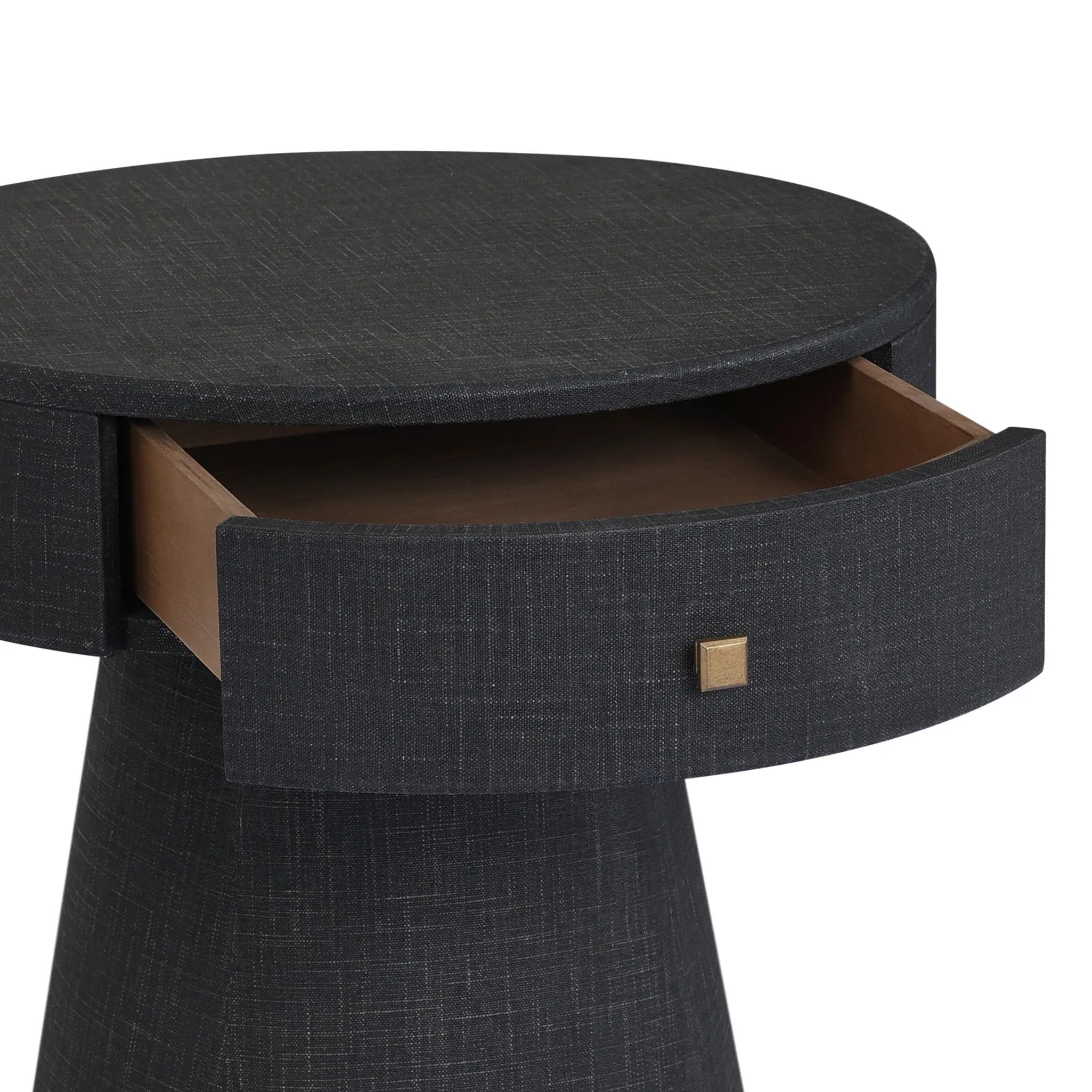 Wrapped in black painted linen, a rounded nightstand features a single drawer and tapered pedestal base, bringing texture plus storage to the bedside Amethyst Home provides interior design, new home construction design consulting, vintage area rugs, and lighting in the Dallas metro area.