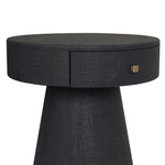 Wrapped in black painted linen, a rounded nightstand features a single drawer and tapered pedestal base, bringing texture plus storage to the bedside Amethyst Home provides interior design, new home construction design consulting, vintage area rugs, and lighting in the Houston metro area.